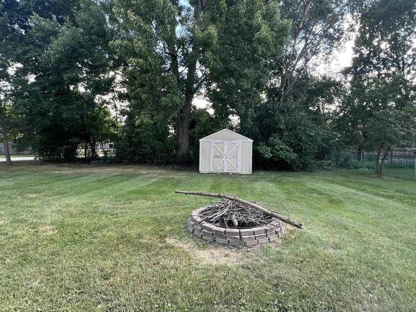 Fire pit and storage shed in the backyard